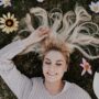 woman lying on flowers